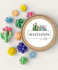 A round kraft paper tin labeled 'SUCCULENTS' with a succulent illustration on the lid, surrounded by colorful wax melt succulent and cactus shapes on a light beige background.