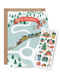 North Pole village sticker card with train and mountains has a sticker sheet to decorate it