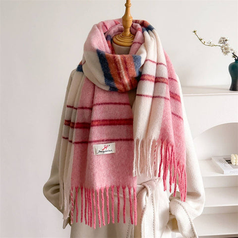 Gradient Pink and white plaid scarf with fringe on a mannequin against a white background