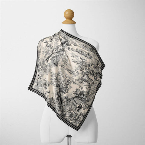 Scarf with black and white pattern on a mannequin against a white background
