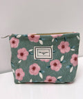 Floral patterned pouch with a visible brand label on a white surface.