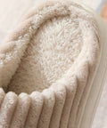 Close-up of a fluffy beige slipper with a soft texture.
