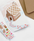 gingerbread house holiday card with candy looking stickers for decorating the gingerbread house