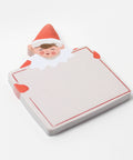 sticky note pad shaped like holiday elf holding large card. elf is dressed in red on green background board