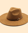 Brown fedora hat with a leather band on a beige background