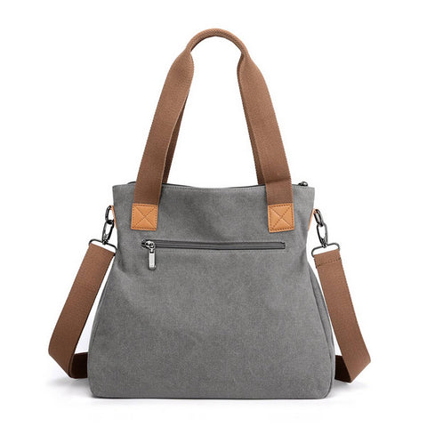 Gray tote bag with brown straps on a white background