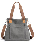 Gray handbag with brown straps on a white background