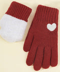 A pair of knit winter gloves in red and white, featuring a white heart detail on the cuff, One glove is inside out to show the soft fuzzy lining. Displayed on a light cream background.